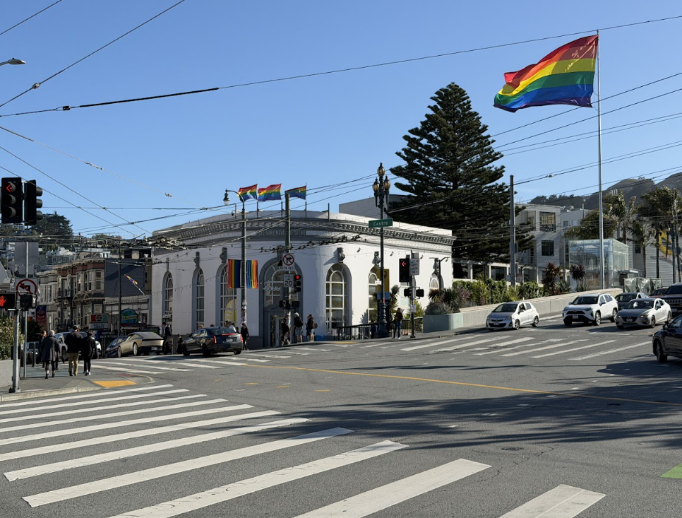 Street view of the Castro District with shopfronts and rainbow flags